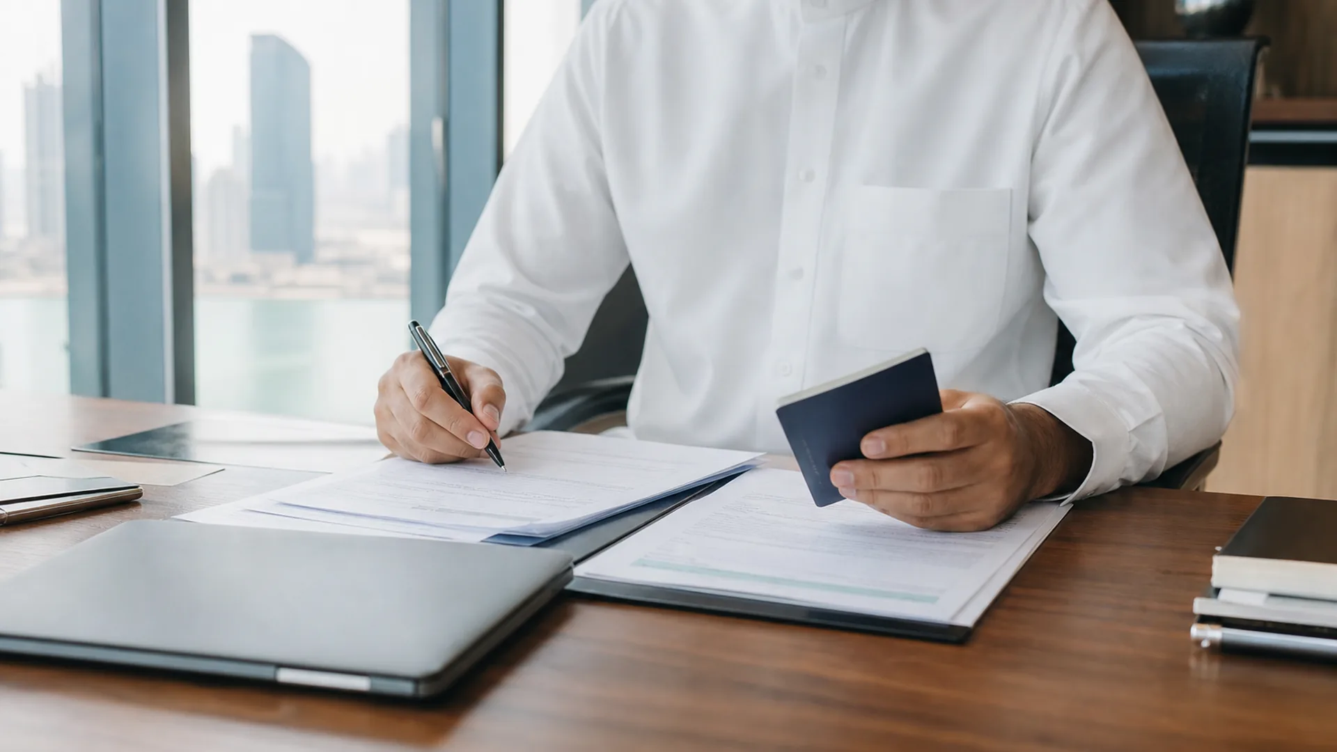 Founder reviewing business formation documents at a modern Gulf office desk