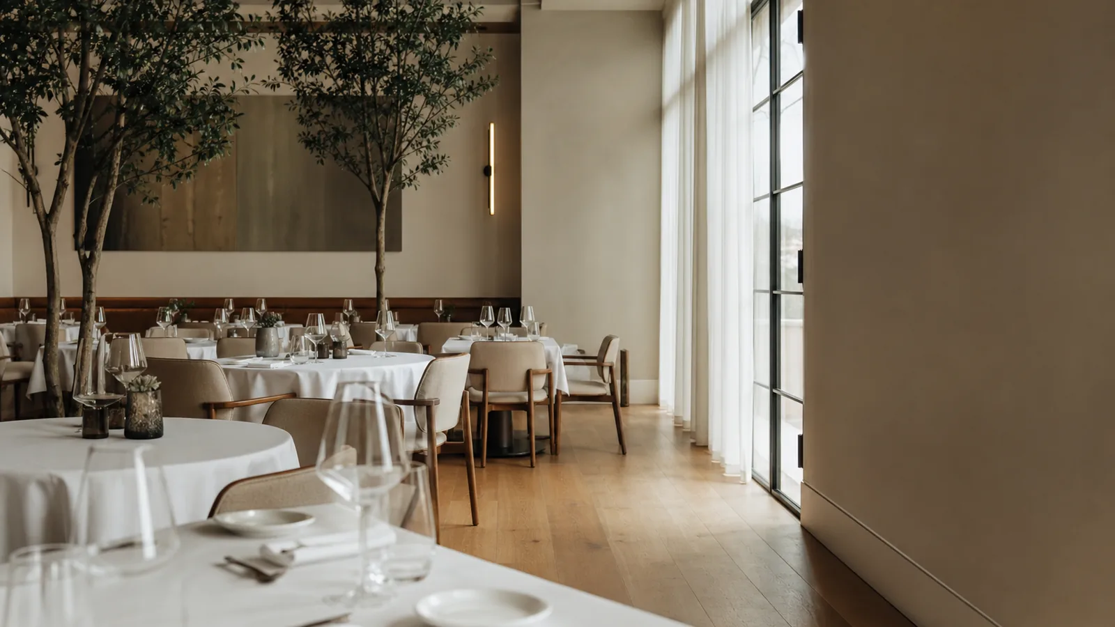 Empty restaurant dining room prepared before service, calm pre-open atmosphere